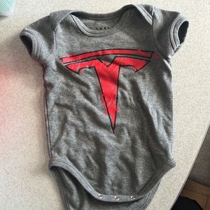 Tesla brand 12 month snap button onesie.